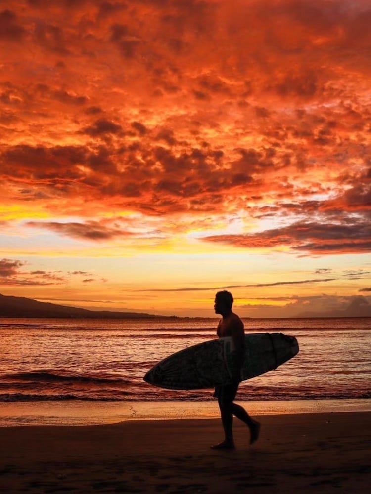 Unique Tahiti - Tahitian Island Tours - Local with a Surfboard at Sunset
