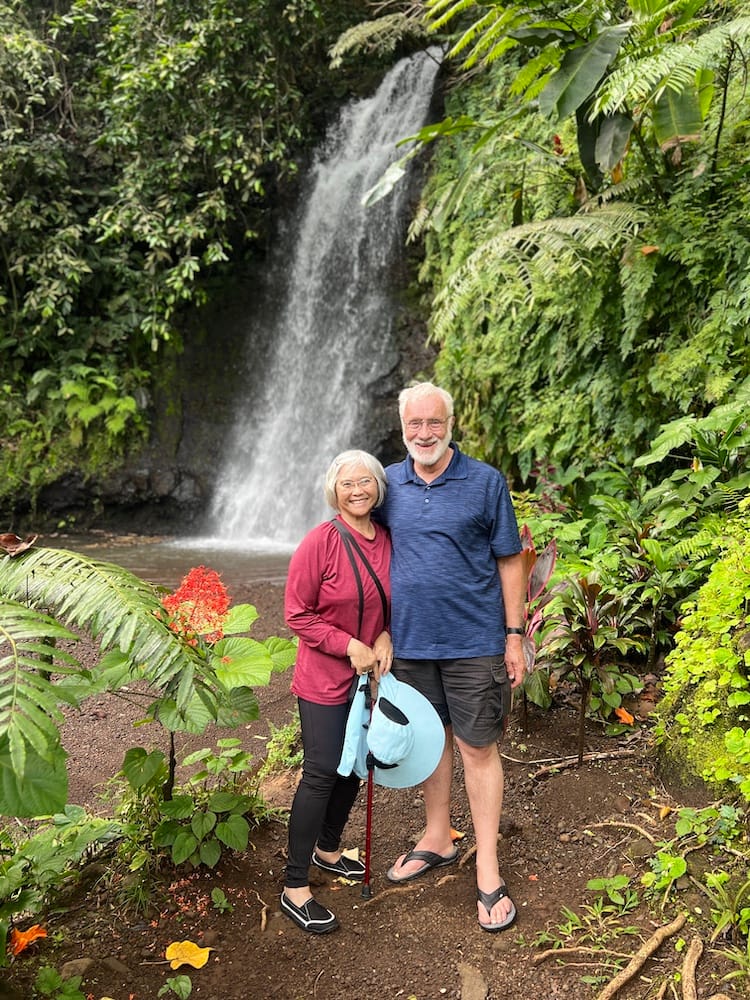 West Coast Half Day Tour of Tahiti - Couple Posed with a Waterfall and Flowers