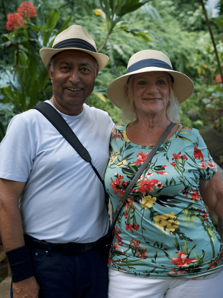 West Coast Half Day Tour of Tahiti - Couple Posing in Front of Flowers and Foliage