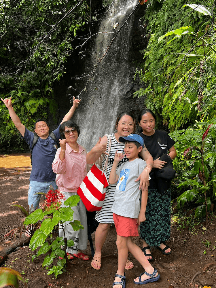 West Cost Full Day Tour of Tahiti - Family Stopping for Photos in Front of Waterfall