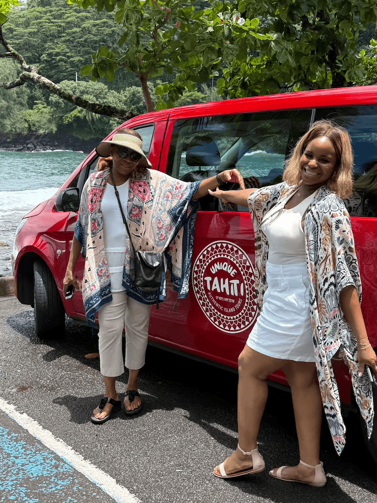 West Cost Full Day Tour of Tahiti - Ladies Smiling and Posing with Signature Red Van