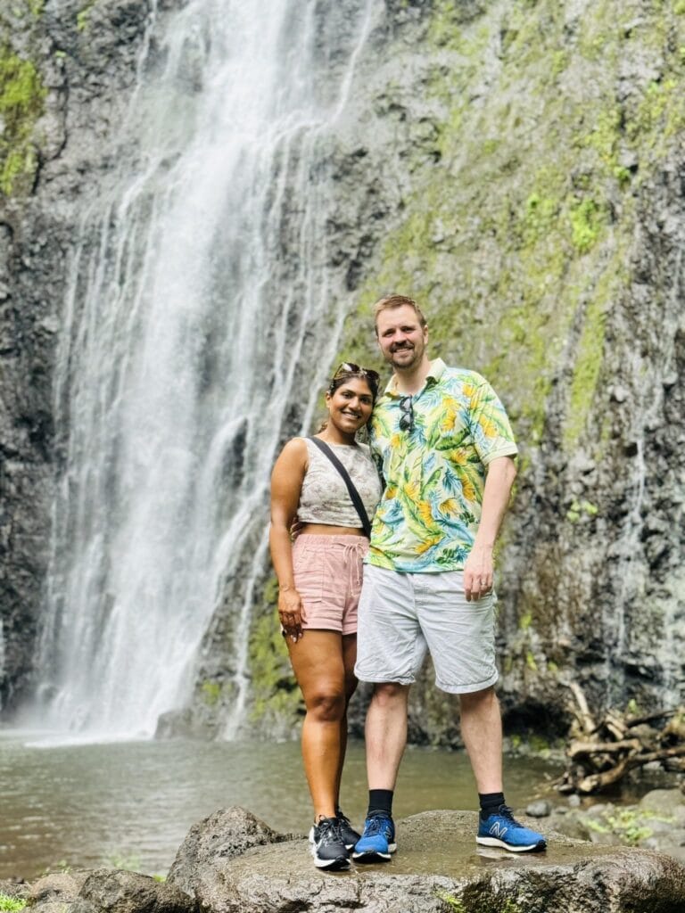 A couple standing in front of a waterfall