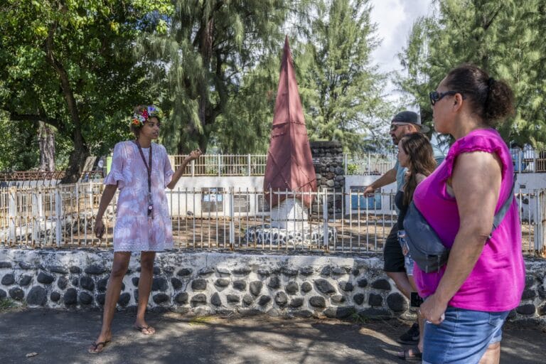 A Tahitian woman talking to tourists